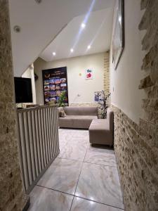 a living room with a couch and a tv at Basha Pyramids Best View in Giza