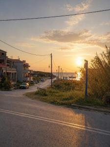 an empty street with the sunset in the background at Memories Studio in Neapoli Voion