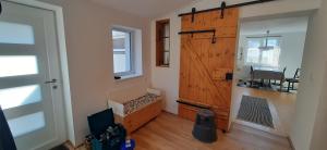 a room with a wooden door and a room with a window at Wein4tel Auszeit in Blumenthal