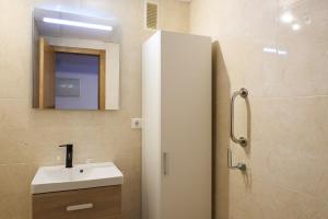 a bathroom with a sink and a mirror at Beach Apartament Playa in El Campello +12 photos