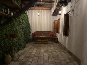 a patio with a bench and a candle on a table at Usman Heritage in Bukhara