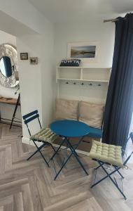 a blue table and two chairs in a room at Atlantic Way Suites Doonbeg Co Clare in Doonbeg