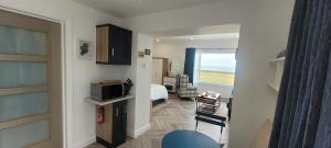 a small room with a bed and a microwave at Atlantic Way Suites Doonbeg Co Clare in Doonbeg