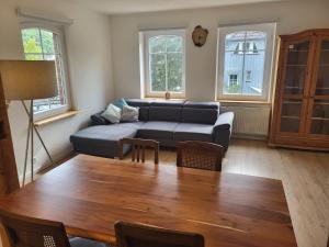 a living room with a couch and a table at Schwarzwaldblick in Schramberg