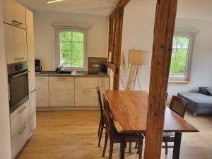 a kitchen and dining room with a wooden table at Schwarzwaldblick in Schramberg