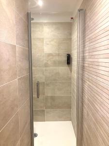 a shower with a glass door in a bathroom at Au Château de Villelongue B&B in Villelongue-dʼAude +55 photos