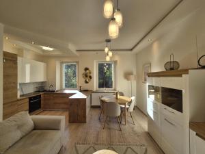 a kitchen and living room with a table and a couch at DORMAR II Apartament in Wałbrzych