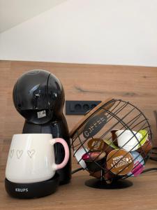 a coffee maker and a cup on a table at Apartma Luvita in Golnik