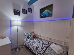 a bedroom with a bed with blue lights on the wall at Roman sunset beach in Ladispoli