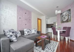a living room with a couch and a table at Seaside Apartments Petrovac in Petrovac na Moru