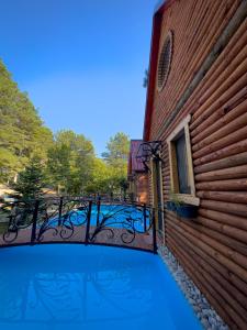 a swimming pool with a balcony on a building at Dajti Alpin Villas in Tirana