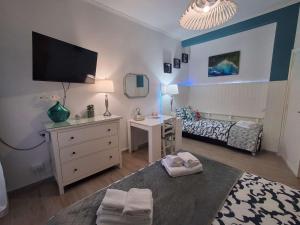 a room with a bedroom with a bed and a desk at Roman sunset beach in Ladispoli