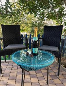 a bottle of champagne on a glass table on a patio at Santorini Odesa in Odesa