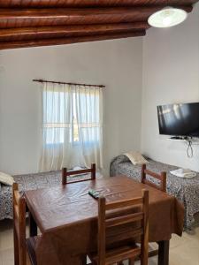 a living room with a table and a couch at Complejo Alto Paraiso in Villa Cura Brochero