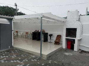 a patio with a fireplace and a table and chairs at 36 the trout lodge in Goodwood