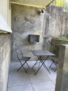 a table and chairs sitting on a patio at Cocon de douceur in La Ravoire