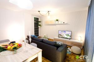 a living room with a couch and a table at Spacious & Central Apartament in Santiago de Compostela