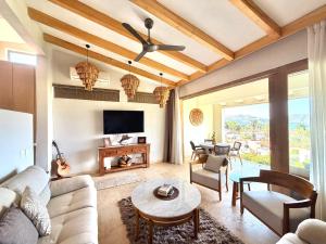 a living room with a couch and a table at Villas Mimosa at La Ropa Beach in Zihuatanejo