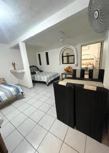 a living room with two beds and a table at Casa De Playa in Agua de Correa