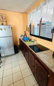 a kitchen with a sink and a refrigerator at Casa De Playa in Agua de Correa