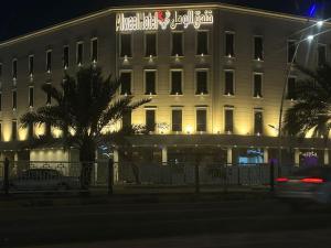 a white building with a sign on the side of it at فندق الوعل بالخفجى in Khafji