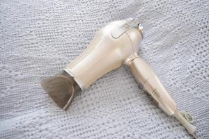 a white flashlight laying on a white blanket at KEI VILLA Tsujido in Takata