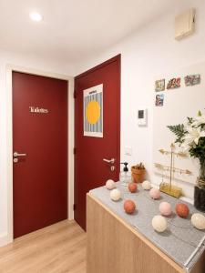 a room with a door and a table with balls on it at Chambre moderne au Petit Bayonne chez particulier in Bayonne