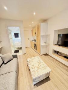 a living room with a couch and a coffee table at Cozy studio Annecy in Poisy