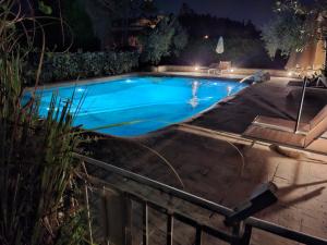 a swimming pool in a backyard at night at Villa Le Statue in Florence