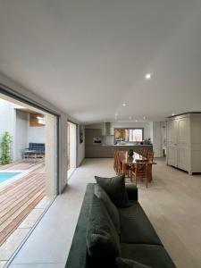 a living room with a couch and a dining room at La Maison des Filles in Agen