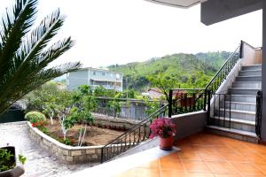 a balcony with stairs and a view of a house at Villa Ekluxe in Delvinë