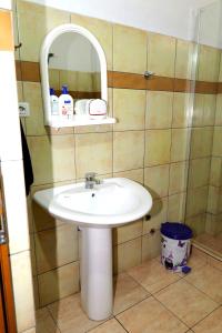 a bathroom with a white sink and a mirror at Villa Ekluxe in Delvinë +9 photos