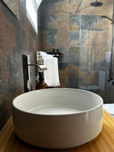 a large white tub in a bathroom with a shower at Coastal Sands Azores in Ribeira Grande