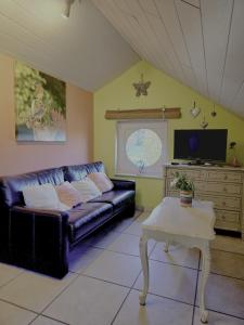 a living room with a couch and a table at L'Orée des Bois in Paliseul