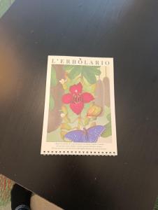 a picture of a card with a flower on a table at Funicolare 64 in Paradiso