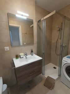 a bathroom with a sink and a shower with a shower at Funicolare 64 in Paradiso