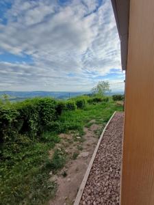 a view from the side of a house with a gravel road at Douglas in Saint-Racho