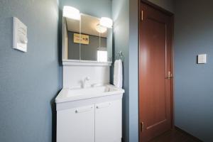 a bathroom with a white sink and a mirror at KEI VILLA Tsujido in Takata +44 photos