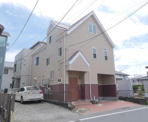 a house with a car parked in front of it at KEI VILLA Tsujido in Takata