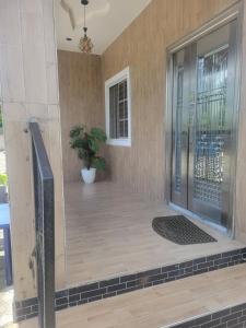 a front door of a house with a potted plant at Kings Garden Inn in Ekrokpe