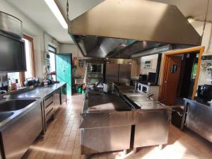 a large kitchen with stainless steel counter tops and counters at B&B La Tenuta del Conte in Fermo