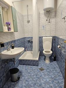a bathroom with a toilet and a sink at Guest House Banana in Dubrovnik +36 photos