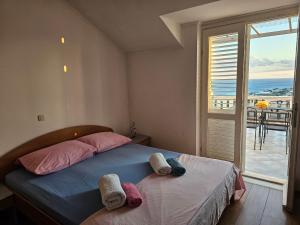 a bedroom with a bed and a view of the ocean at Guest House Banana in Dubrovnik
