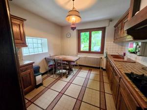 a kitchen with a table and a dining room at Maison BAVANS in Bavans