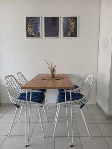 a dining room table with four chairs and a table with a plant on it at La Via dei Trabocchi in San Vito Chietino