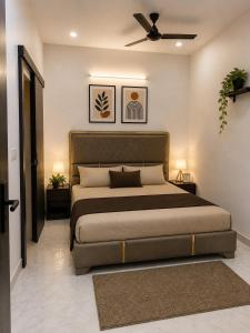 a bedroom with a large bed and a ceiling fan at BTL Kamakshi homez , 3bhk free parking, open dining, balcony in Ludhiana