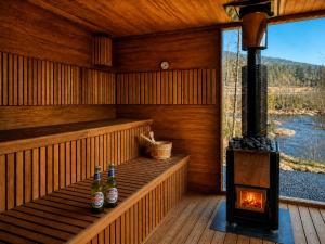 a sauna with two bottles of beer and a wood stove at Koselig Hytte i Hemsedal with outdoor Sauna in Hemsedal