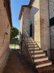a brick building with stairs leading to a door at Il Casale del Tiglio in Monteleone dʼOrvieto