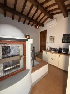 a kitchen with a fireplace in the middle of a room at Il Casale del Tiglio in Monteleone dʼOrvieto