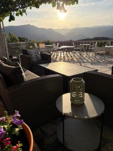 a patio with couches and a table with a view at Estrela do Gerês - Casa Fernandes in Outeiro +81 photos